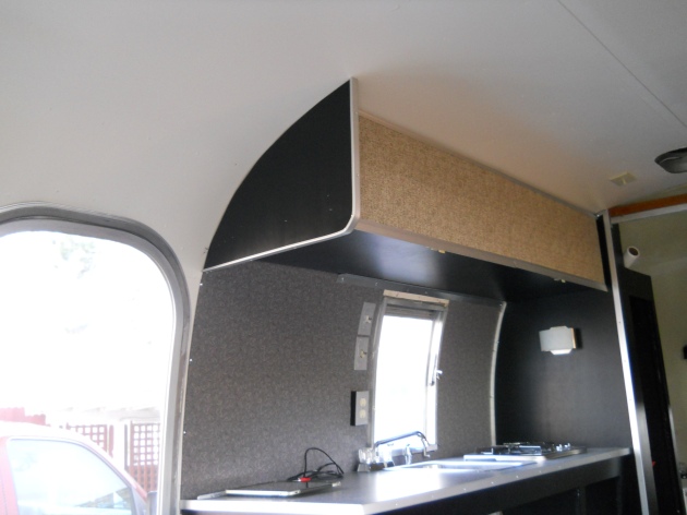 Upper curb side cabinet.  Doors covered in fabric.