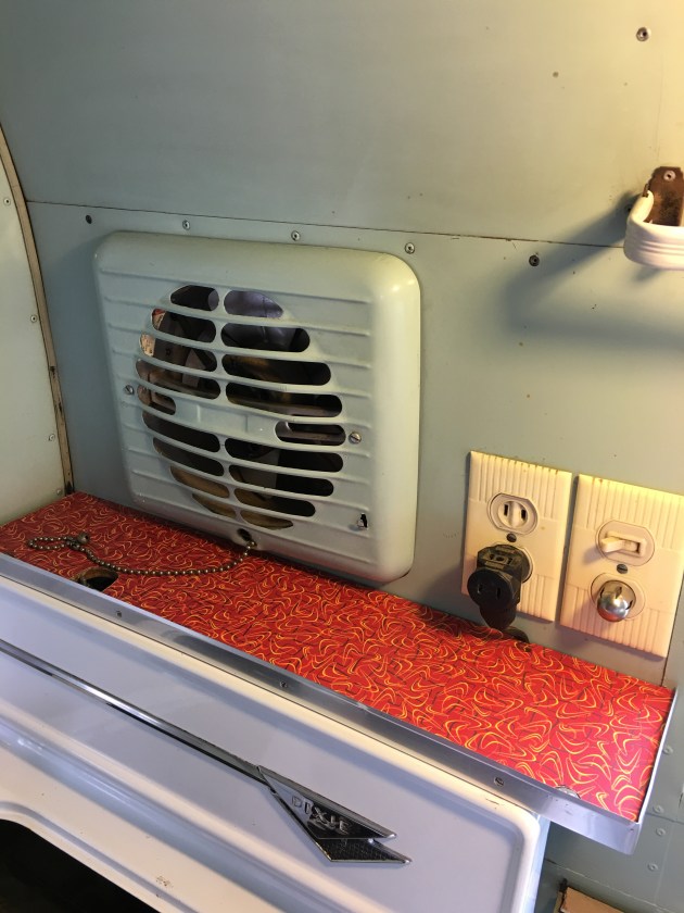 Shelf above stove. I ADORE that fan. 